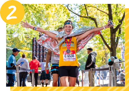 A marathon runner for Team RMHC celebrates after the race.